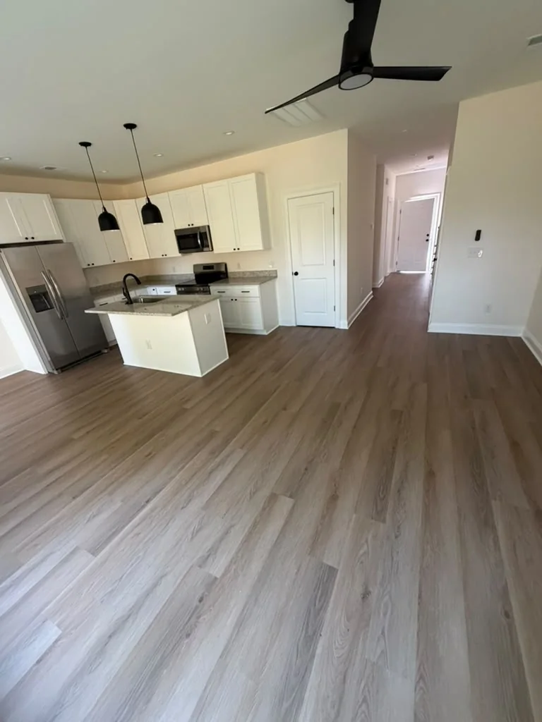 Vinyl flooring installation in an open kitchen and living area